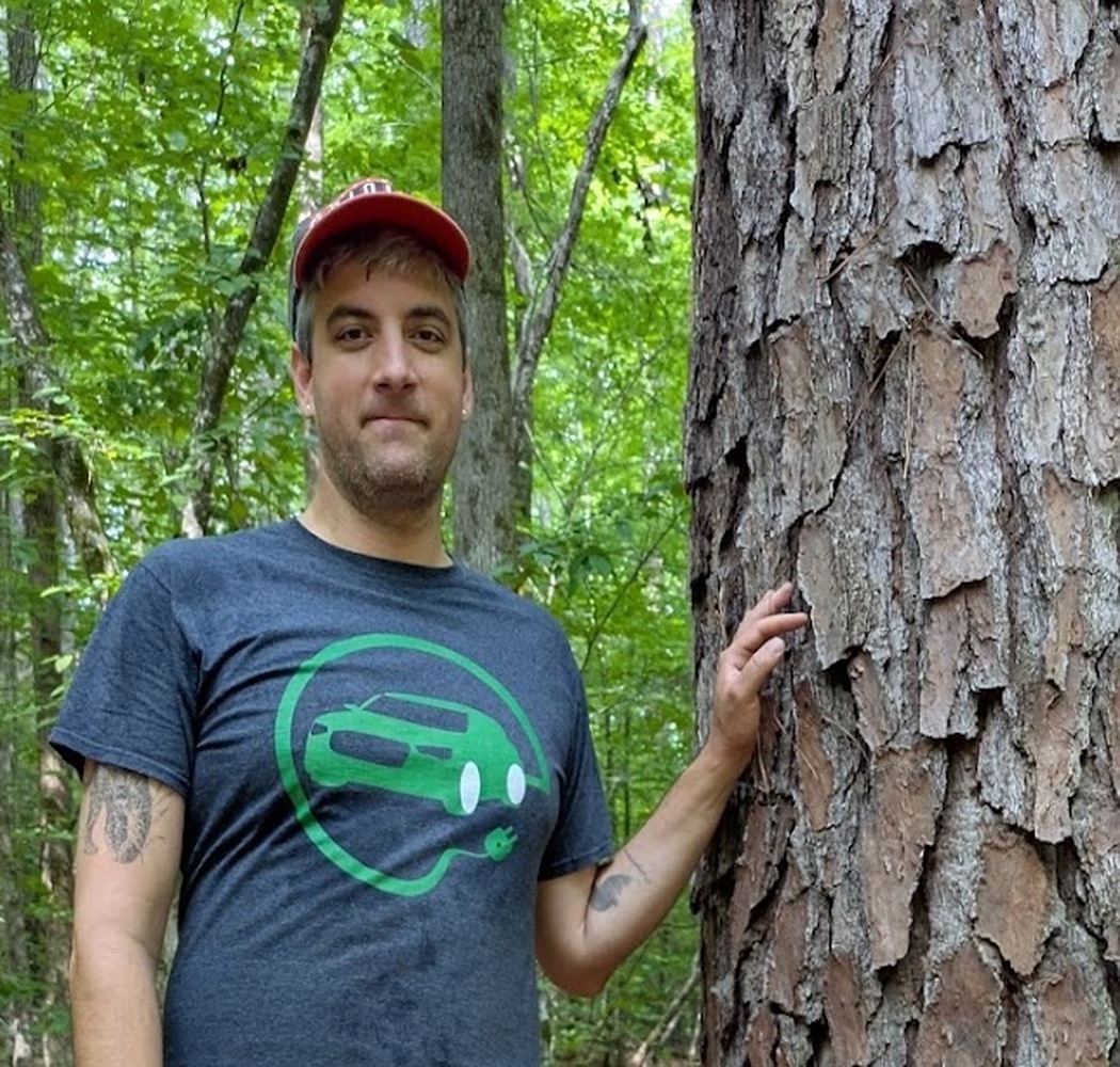 Jacob Socolar beside a pine tree in Duke Forest